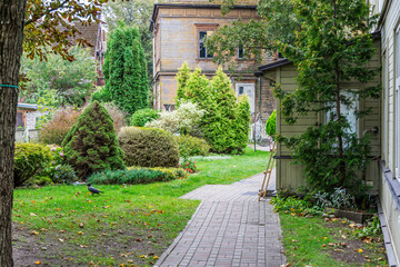 Backyard Garden Path with Historic Wooden House