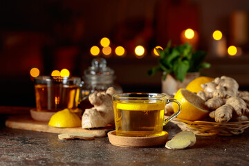 Cup of ginger tea with lemon, honey, mint, and ginger root.