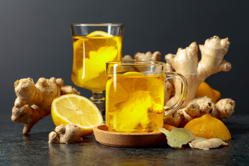 Ginger tea with lemon on a black background.