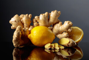 Ginger with lemon on a black background.