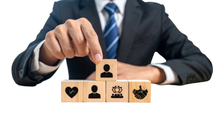Person in suit places a figure icon on top of other icons on wood blocks