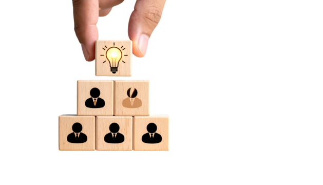 Hand places lightbulb block atop team blocks, forming pyramid on black