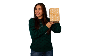 Happy woman holding a christmas gift, smiling with joy, celebrating festive winter holidays on transparent background