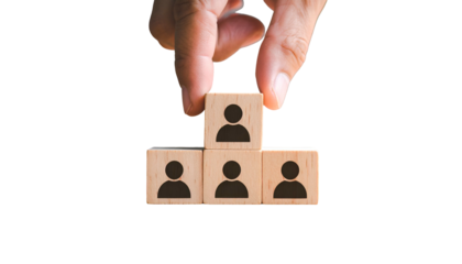 Hand arranging wooden blocks with person icons, symbolizing hierarchy & team