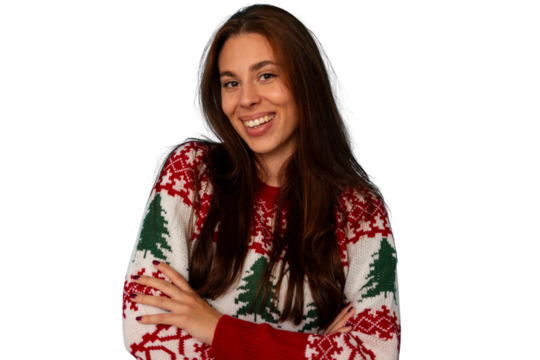 Young woman smiling, wearing festive christmas holiday sweater, arms crossed, happy, cheerful, transparent background