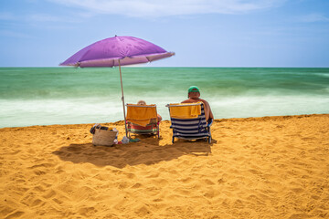Relaxing at Isla Canela beach under a colorful umbrella