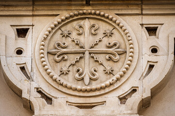 Dominican stone emblem at Magdalena church in Seville, Spain