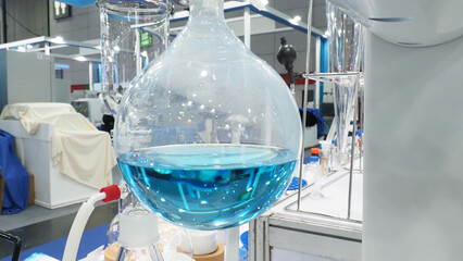 A large round bottom flask filled with a blue liquid.