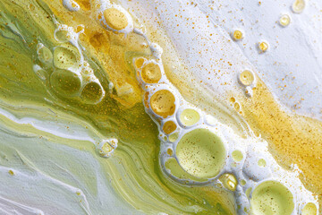 Abstract macro liquid art with green and yellow oil bubbles, white paint texture and golden glitter, artistic fluid background, modern minimalist pattern, organic trendy design, vibrant colors

