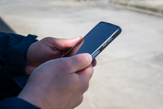 Smartphone in male hands - Powered by Adobe