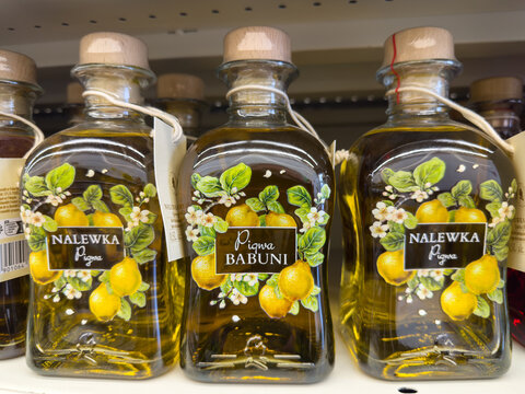 Klagenfurt, Austria - October 29, 2025: Colorful bottles of Nalewka Babuni fruit liqueur displayed on a shelf, showcasing vibrant labels and decorative designs, perfect for culinary enthusiasts