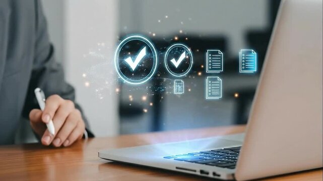 Businessman using stylus to check off tasks on a digital interface with glowing icons and a laptop