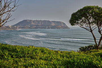 warm sunny afternoon in Miraflores, with the Pacific breeze and El Morro Solar rising in the...