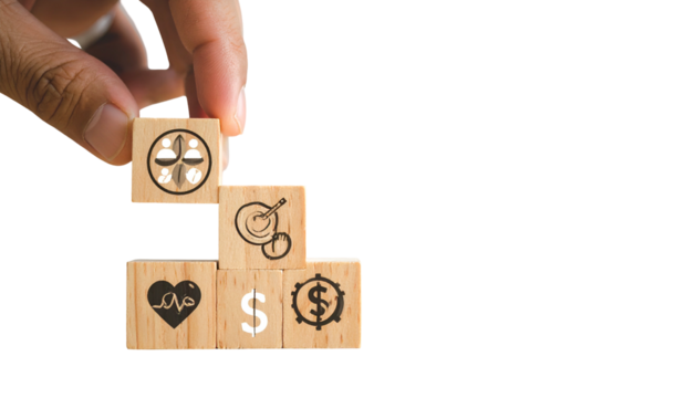 Hand stacking wooden blocks with symbols community, health, finances, and resources