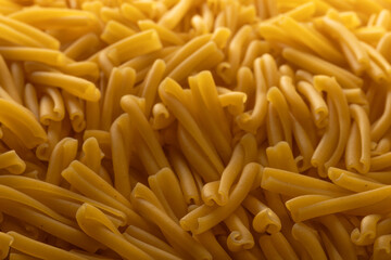 Dry Casarecce Pasta Background, Top View of Uncooked Italian Noodles