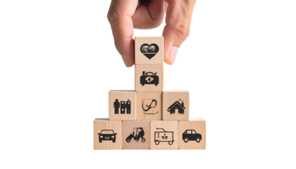 Hand building a pyramid of wooden blocks with health, life, and property insurance icons