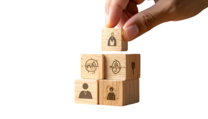 Hand places a cube with figure atop a wooden block pyramid. Cubes show career icons