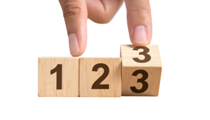 Hand flips a wooden die from 3 to show another 3, adjacent to blocks with 1 & 2