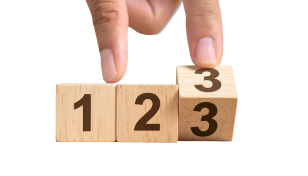 Hand flips a wooden die from 3 to show another 3, adjacent to blocks with 1 & 2