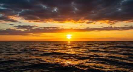 Dynamic golden hour view of the ocean horizon. Dramatic sky reflecting vibrant hues on the choppy water surface and endless rolling waves ,ripple ,marine ,atmospheric