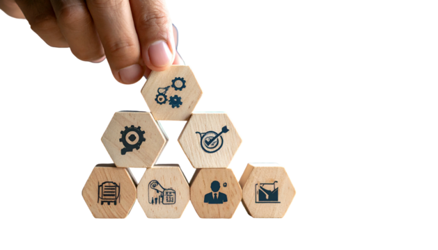 Hand building a wooden block pyramid with strategy icons, on black background