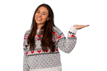 Young woman smiling, holding an open palm, wearing a christmas sweater with hearts and a reindeer, ready for holiday promotions
