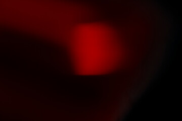 Abstract motion blur of bright red and orange city street lights creating a dark, colorful bokeh fire effect