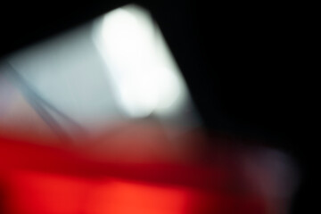 Abstract motion blur of bright red and orange city street lights creating a dark, colorful bokeh fire effect