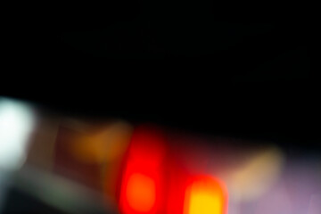 Abstract motion blur of bright red and orange city street lights creating a dark, colorful bokeh fire effect