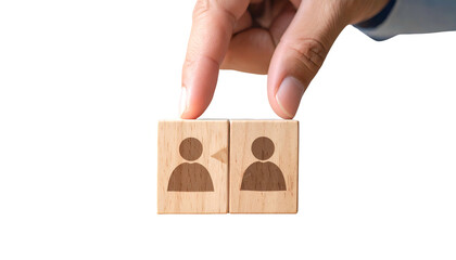 Hand placing blocks with people icons, symbolizing teamwork or interaction, against black