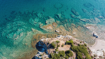 Rocky and slightly wavy waters in drone view
