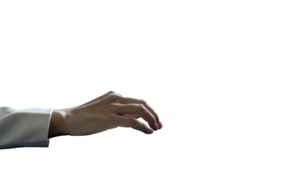 Close-up of a hand reaching, set against a stark black background, wearing a white shirt