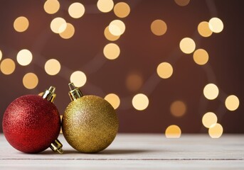 Festive decorative spheres in red white and gold featuring shimmering reflections against a blurry backdrop of glowing holiday bokeh ,decorative ,soft ,bauble