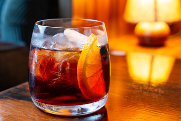 Negroni drink. Campari, gin, vermouth, garnished with an orange.