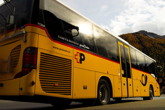 zernez, graubuenden, switzerland - 21 10 2025: a beautiful yellow postbus