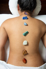 Woman receiving spa treatment. Therapy with energy stones. View from above.