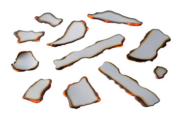 Scattered burnt paper pieces with glowing orange edges, isolated on transparent background