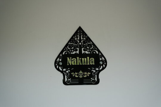 Unique carved sign displaying 'Nakula' adds character and charm to any space, perfect for homes, businesses, or cultural projects needing unique design