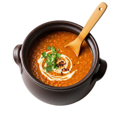 A bowl of lentil soup with cream swirl and parsley garnish with a wooden spoon inside it