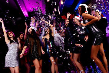 Energetic party celebration stylish nightclub with dancers friends crowd celebrating Christmas new...