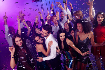 Energetic party crowd dances with friends at a neon nightclub celebration full of music fun and joy