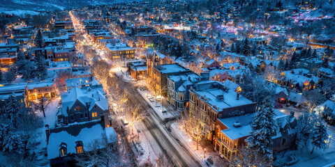 Winter City Lights: An aerial view captures a cityscape draped in a serene blanket of snow, with a network of twinkling lights, creating a magical atmosphere.
