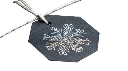 Modern gift in graphite paper with white geometric snowflake and thin silver thread, architectural design, isolated on white background