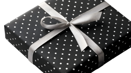 Modern gift in matte black paper with minimalist white dot pattern and thin white ribbon, sleek and elegant, isolated on white background