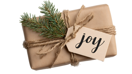 Rustic gift box in brown kraft paper with hand-lettered "Joy" tag, pine sprig, and natural twine bow, isolated on white background