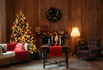 Blurred, cozy Christmas interior with a decorated tree, glowing lights, fireplace mantel, holiday table setting, and rustic furniture.