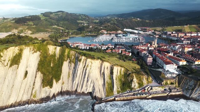 Aerial view of coastal cliffs and harbor in Basque Country, northern Spain