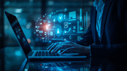 Futuristic business technology is illustrated by an individual using a laptop and tablet, enhanced with holographic digital interface overlays and floating icons.