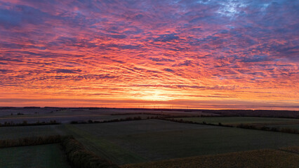 Vineyard and Countryside Fields at Sunset Under Vibrant Cloud-Filled Sky