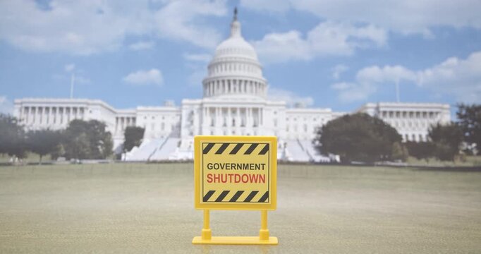 Close-up of yellow &ldquo;Government Shutdown&rdquo; sign in front of the U.S. Capitol building. Visual metaphor for budget freeze, federal services halt, political deadlock and economic danger.